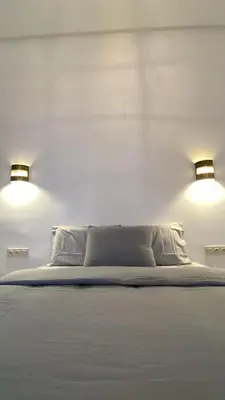 a bedroom with two lights above a bed at Welcome to Riad Mariam & Maïwenn! in Marrakech