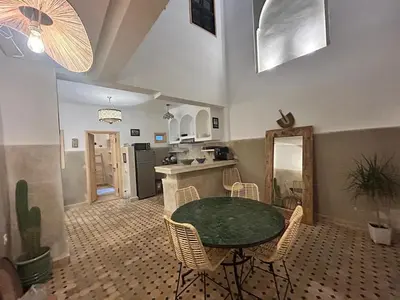 a kitchen with a table and chairs in a room at Welcome to Riad Mariam & Maïwenn! in Marrakech