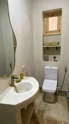 a bathroom with a sink and a toilet and a mirror at Welcome to Riad Mariam & Maïwenn! in Marrakech