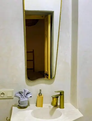 a bathroom with a sink and a mirror at Welcome to Riad Mariam & Maïwenn! in Marrakech