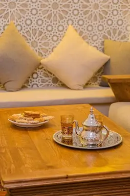 a tea kettle and a plate of food on a table at Riad ZEROUAL in Marrakech