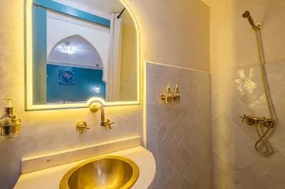 a bathroom with a sink and a window at Riad ZEROUAL in Marrakech