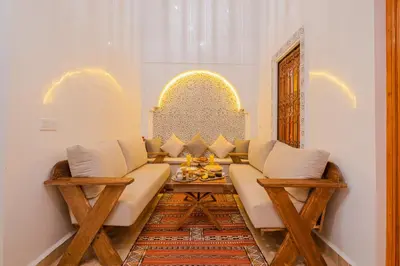 a living room with a couch and a table at Riad ZEROUAL in Marrakech