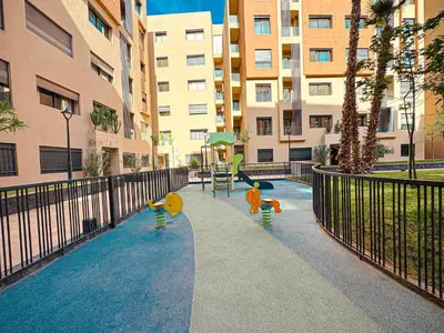 three children playing on a sidewalk in front of a building at Le Pavillon Gueliz Appart Chic Confort et Piscine in Marrakech