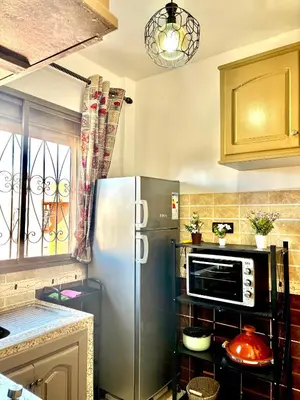 a kitchen with a refrigerator and a microwave at Zyarat Marrakech in Marrakech