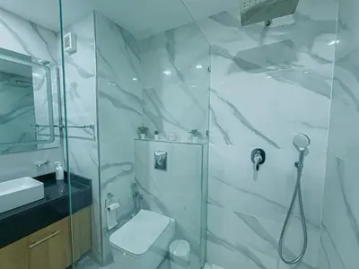 a bathroom with a shower and a toilet and a sink at Essalmi Luxury Apartment Gueliz in Marrakech