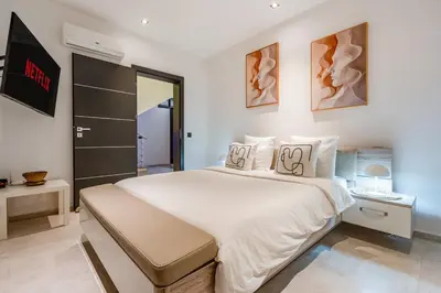 a bedroom with a large white bed in a room at villa golfe in Marrakech