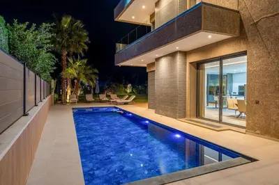 an infinity pool in the backyard of a house at villa golfe in Marrakech