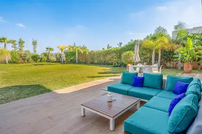 a living room with a blue couch and a table at villa golfe in Marrakech