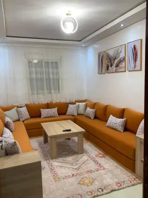 a living room with a couch and a table at New Apart Marrakech 2 BR-5 MN from airport in Marrakech