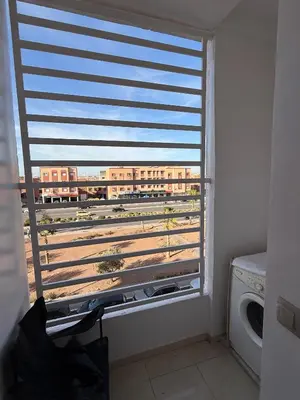 a window in a room with a view of a train at New Apart Marrakech 2 BR-5 MN from airport in Marrakech
