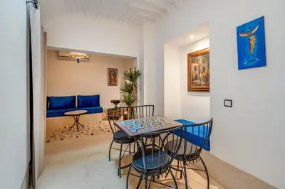 a living room with a table and chairs at Riad with Rooftop Terrace in Top Medina Location, Dar El Bacha in Marrakech