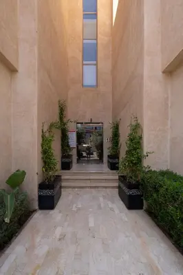 a hallway with potted plants in a building at Marrakech in Marrakech