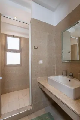 a bathroom with a sink and a mirror at Marrakech in Marrakech
