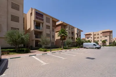 a van parked in a parking lot in front of buildings at Marrakech in Marrakech