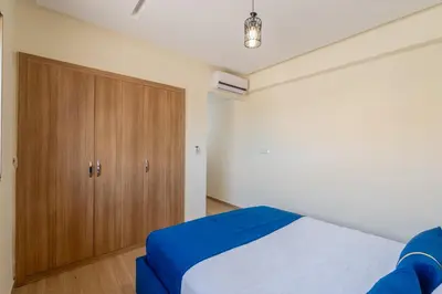 a bedroom with a bed and a wooden cabinet at Marrakech in Marrakech