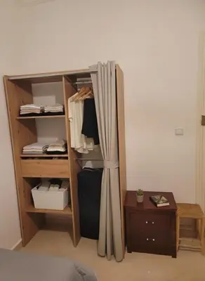 a room with a closet with a curtain and a table at Dar'ESTRELLA calme 15min Jemaa ElFna parking free in Marrakech