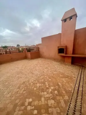 an empty courtyard of a building with a brick floor at Séjours villa riad pour familles in Marrakech