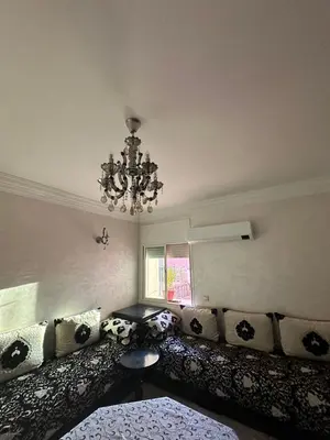 a living room with a couch and a chandelier at Bouchouk Apparts Gueliz in Marrakech