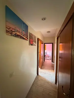 a hallway with two paintings on the walls of a house at Bouchouk Apparts Gueliz in Marrakech