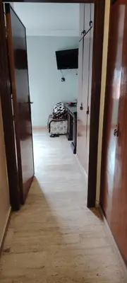 a hallway with two doors and a room with a bed at Bouchouk Apparts Gueliz in Marrakech