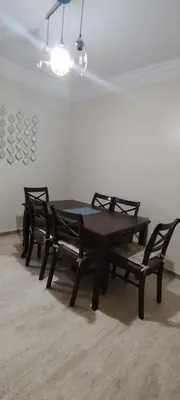a table and two chairs in a room at Bouchouk Apparts Gueliz in Marrakech