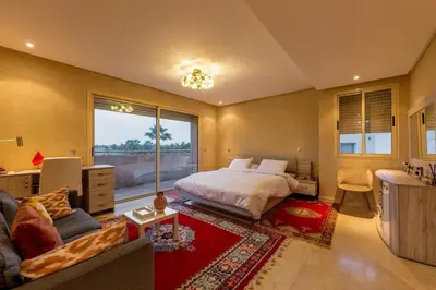a bedroom with a bed and a living room at Villa Sophia in Marrakech