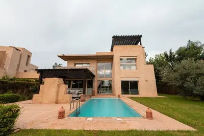 a house with a swimming pool in front of it at Villa Sophia in Marrakech
