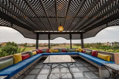 a covered patio with a couch and a table at Villa Sophia in Marrakech