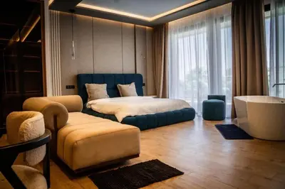 a bedroom with a bed and a chair and a couch at Villa California in Marrakech