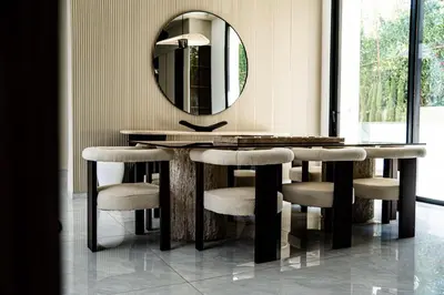a dining room table with chairs and a mirror at Villa California in Marrakech