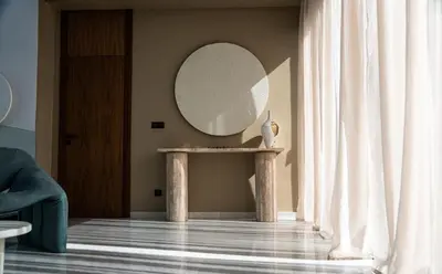 a round mirror on a table in a room at Villa California in Marrakech