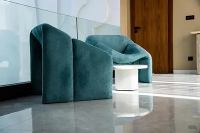 two green chairs and a table in a room at Villa California in Marrakech