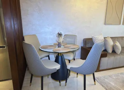 a dining room with a table and chairs and a couch at New apartment - Gueliz - Pool in Marrakech