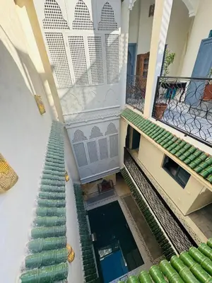 an overhead view of a building with stairs and a pool at Riad Blue Berry in Marrakech