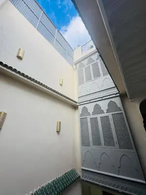 a wall with a door with a window on it at Riad Blue Berry in Marrakech