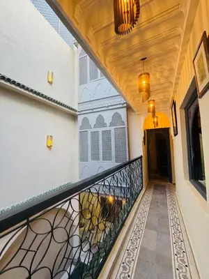 a hallway of a house with a wrought iron railing at Riad Blue Berry in Marrakech