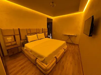 a bedroom with a bed and a television on a wall at Modern & Central Apartment in Marrakech