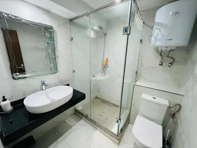 a bathroom with a shower and a toilet and a sink at Modern & Central Apartment in Marrakech