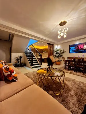 a living room with a couch and a table at Duplex familiale au centee du Marrakech in Marrakech