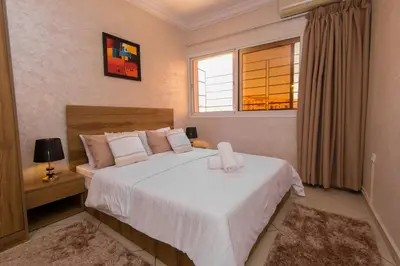 a bedroom with a large white bed with a window at Duplex familiale au centee du Marrakech in Marrakech
