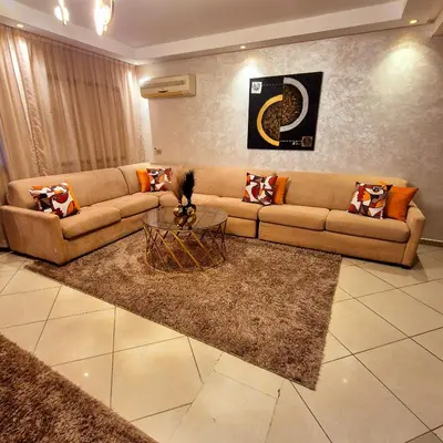 a living room with a couch and a table at Duplex familiale au centee du Marrakech in Marrakech