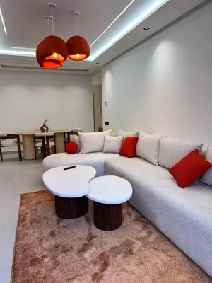 a living room with a couch and two tables at Aube d hivernage Marrakech in Marrakech