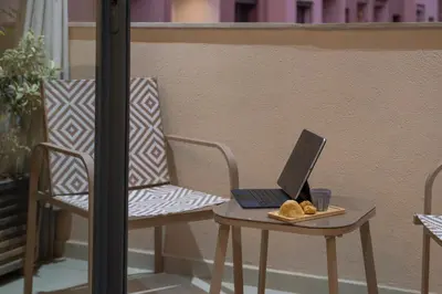 a laptop computer sitting on a table on a balcony at Appartement Chic M Avenue, Balcon, Piscine, Parking Wi-Fi Haut Débit Marrakech in Marrakech