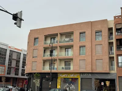 a building on a street with cars parked in front of it at Downtown Prestige 2Br apartment cinema AC in Marrakech