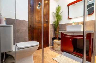 a bathroom with a toilet and a sink and a mirror at Appartement Luxe et Prestige, calme avec piscine in Marrakech