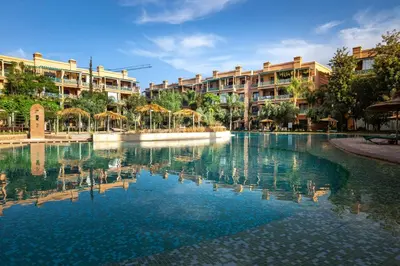 a swimming pool in front of some apartment buildings at Appartement Luxe et Prestige, calme avec piscine in Marrakech
