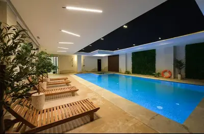 a large swimming pool with benches in a building at Luxurious 2 Bedrooms in Gueliz Pool View in Marrakech