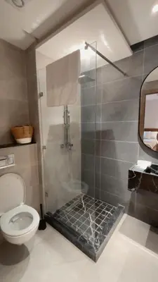 a bathroom with a shower and a toilet at Luxurious 2 Bedrooms in Gueliz Pool View in Marrakech
