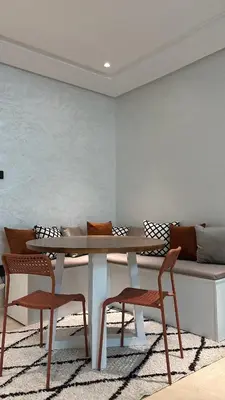 a table and two chairs and a couch in a room at Luxurious 2 Bedrooms in Gueliz Pool View in Marrakech